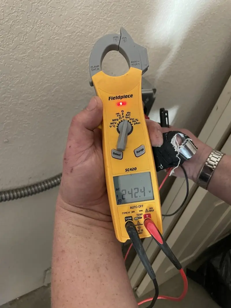 Voltage testing with clamp meter during Whole House Surge Protector in East Manchester